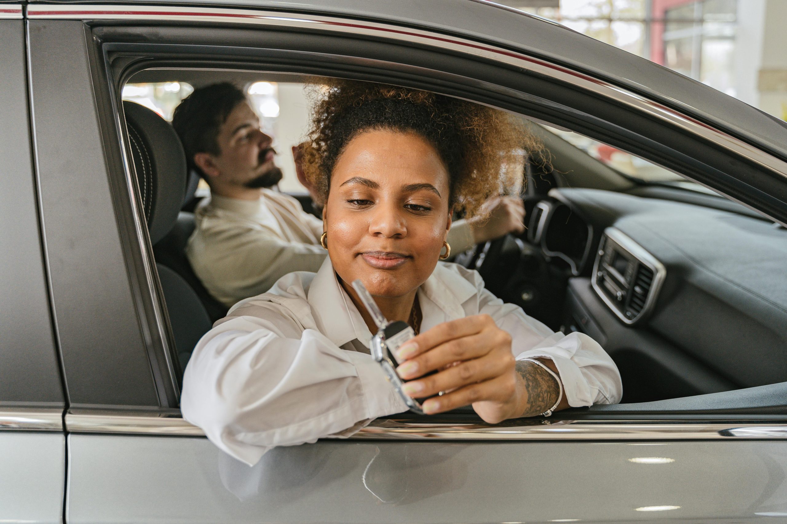 Happy Motoraas members with their car keys showing satisfaction with car support service